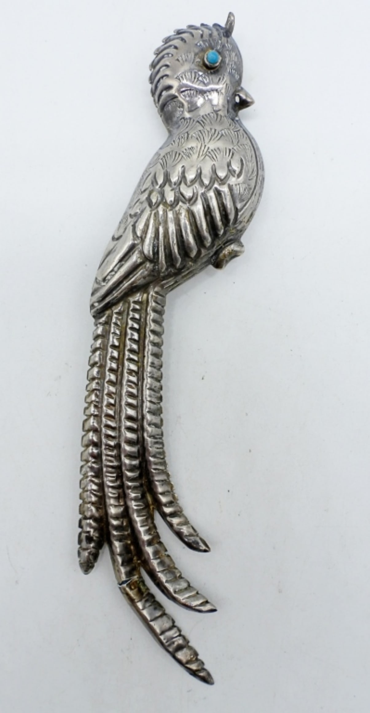 MEXICO STERLING QUETZAL BROOCH: VINTAGE MEXICO STERLING QUETZAL BROOCH. TAIL HAS A CRACK. TURQUOISE GEMSTONE EYE. 6.5" LONG. (15 DWT)