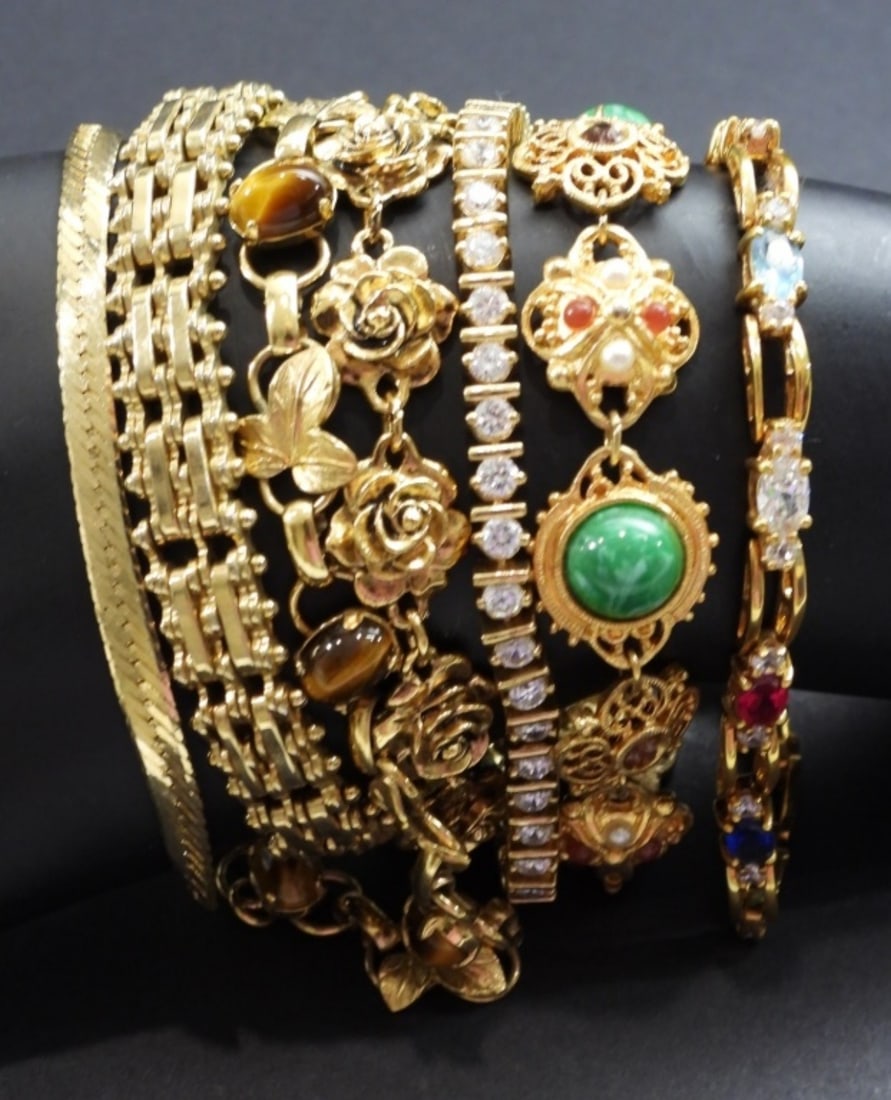 (7) FASHION BRACELETS - GOLD TONE: SOME WITH STONES , VARIOUS SIZES & DISIGNORS