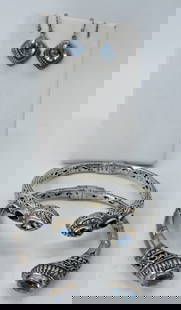 (2) STERLING 18K HINGED CUFF BRACELETS: TWO STERLING SILVER BRACELETS WITH 18K YG ACCENTS. BLUE TOPAZ, AMETHYST & GARNET GEMSTONES. 8". BLUE TOPAZ STERLING PIERCED EARRINGS. (34 DWT)