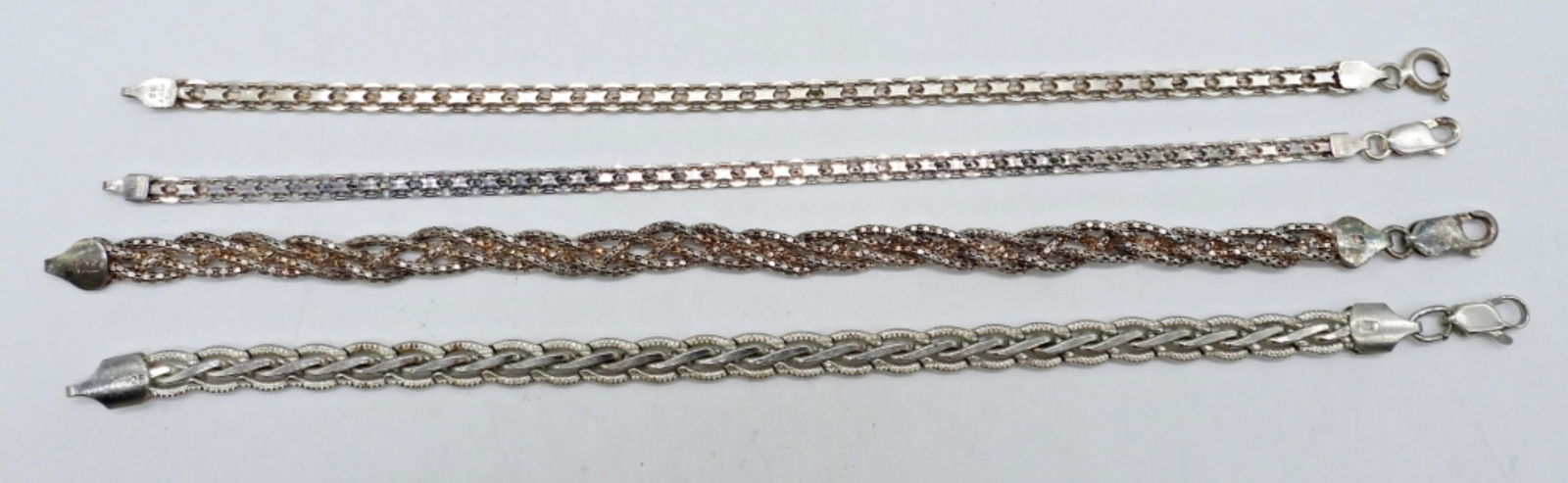 (4) STERLING CHAIN BRACELETS: FOUR STERLING CHAIN BRACELETS, 7". (18 DWT)