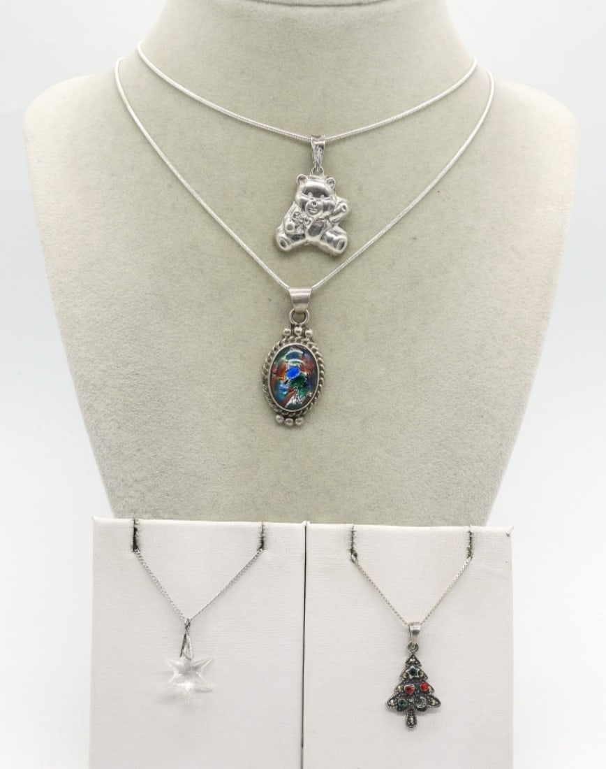 (4) STERLING FASHION NECKLACES: FOUR STERLING FASHION NECKLACES. MEXICO MULTI COLOR GLASS CABOCHON, BEAR, CHRISTMAS TREE & CRYSTAL STAR. CHAINS ARE 14", 18" & 22" (20 DWT)