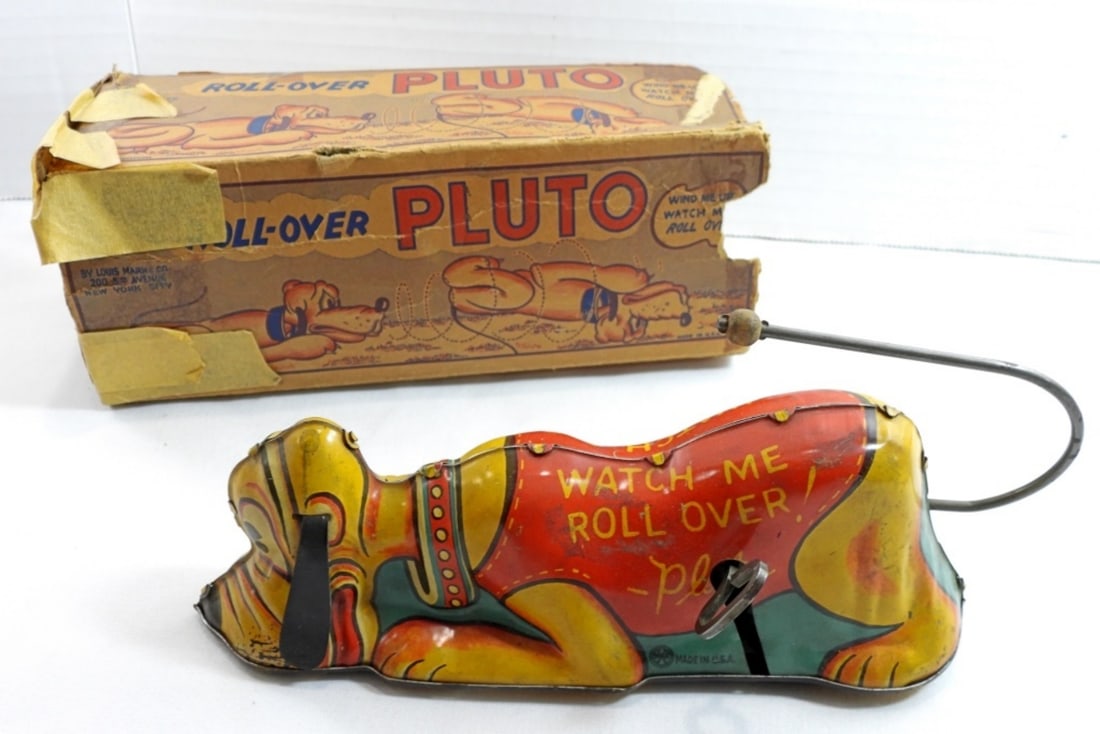 1939 Walt Disney Marx Wind up Pluto "watch me rol: Pluto has an ear missing, but is still in good working conition. No scratches, chipped paint only.