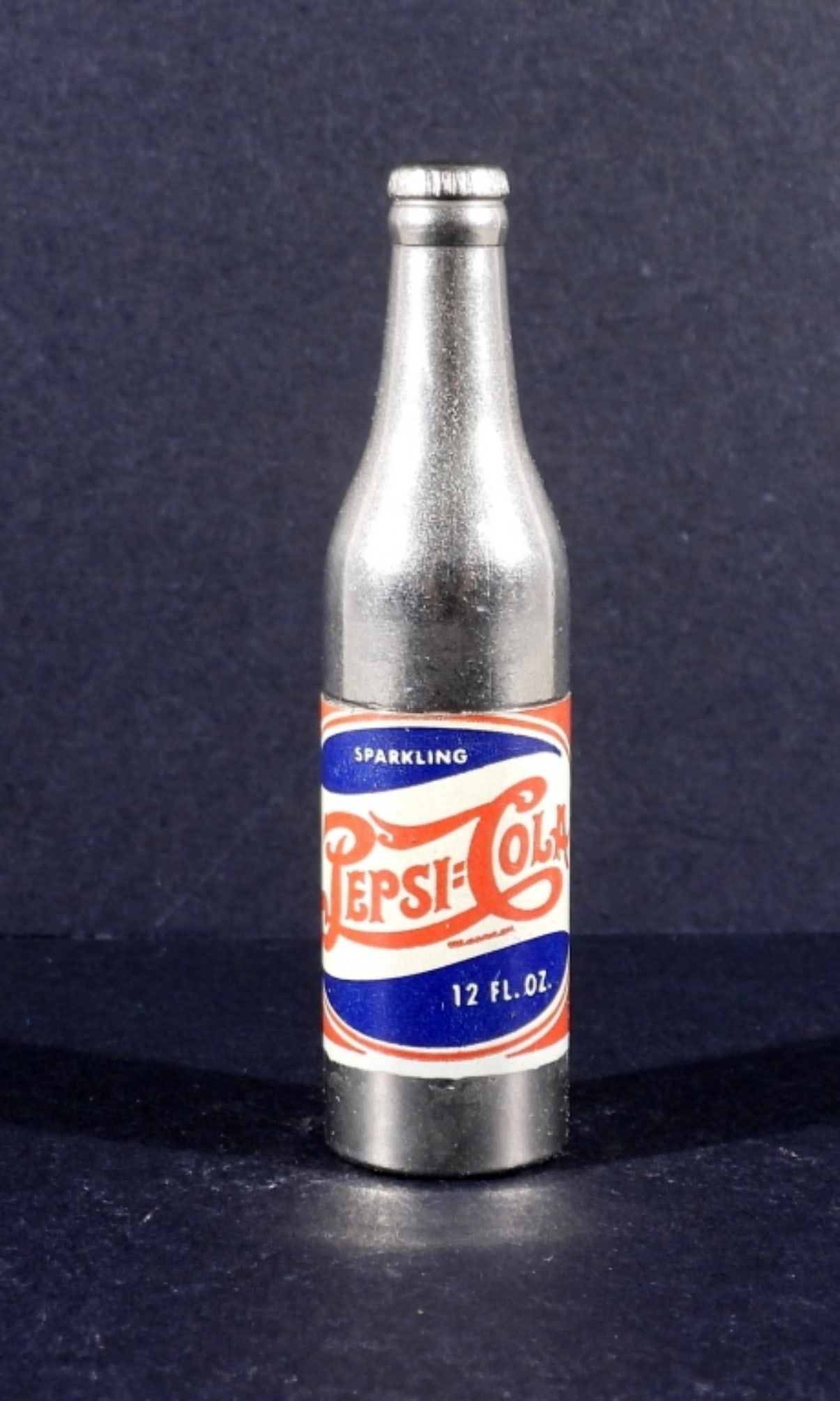 PEPSI COLA TRENCH STYLE LIGHTER W. BOX: PEPSI COLA TRENCH STYLE LIGHTER, UNFIRED. IN ORIGINAL BOX, BUT ONE END OF THE BOX IS MISSING. SEE PHOTOS. 2.5" TALL.