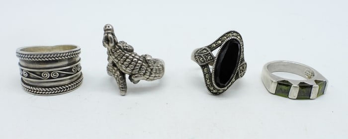 FOUR STERLING FASHION RINGS