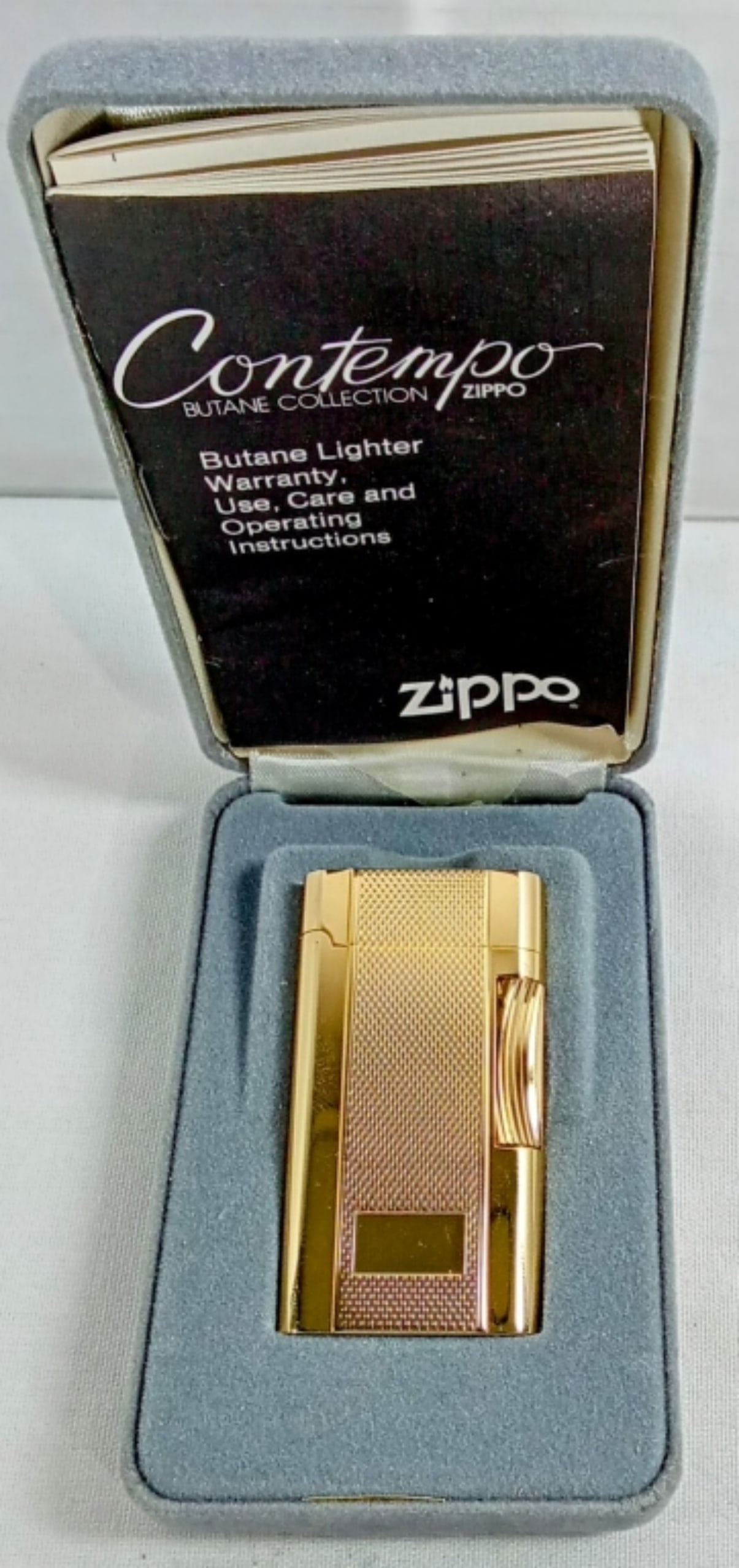 1980'S FIRED CONTEMPO BUTANE ZIPPO: IN A ZIPPO BOX, CONTEMPO BUTANE COLLECTION, GOLD MESH, LOOKS TO HAVE BEEN FIRE