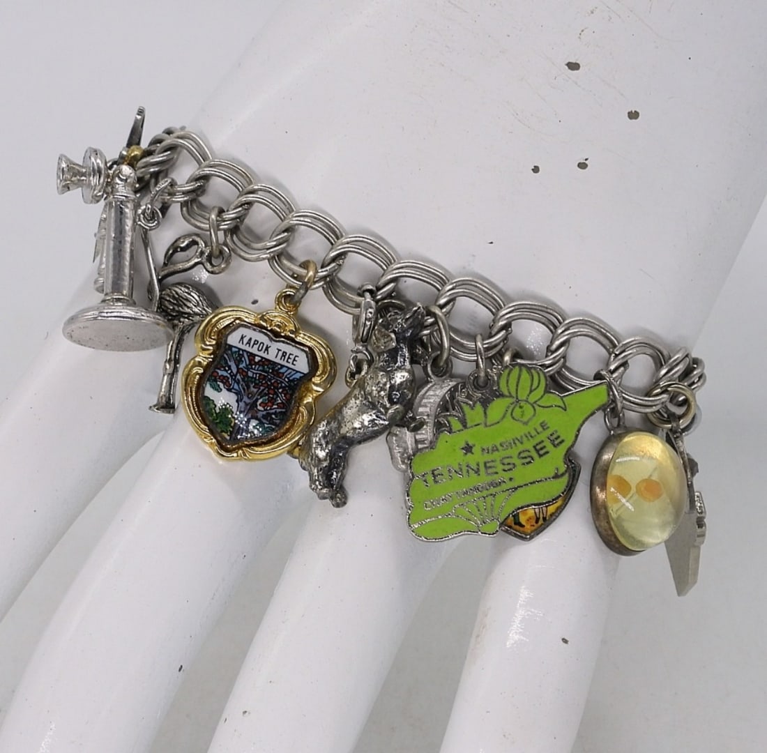 STERLING CHARM BRACELET: STERLING CHARM BRACELET, 8". 15 CHARMS. (28.4 DWT)
