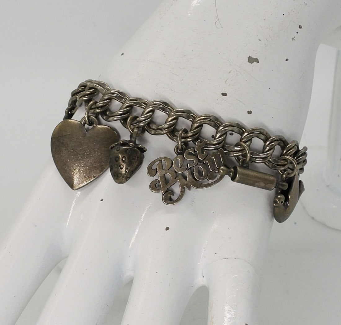 STERLING CHARM BRACELET: STERLING CHARM BRACELET, 9 CHARMS. (29.3 DWT)
