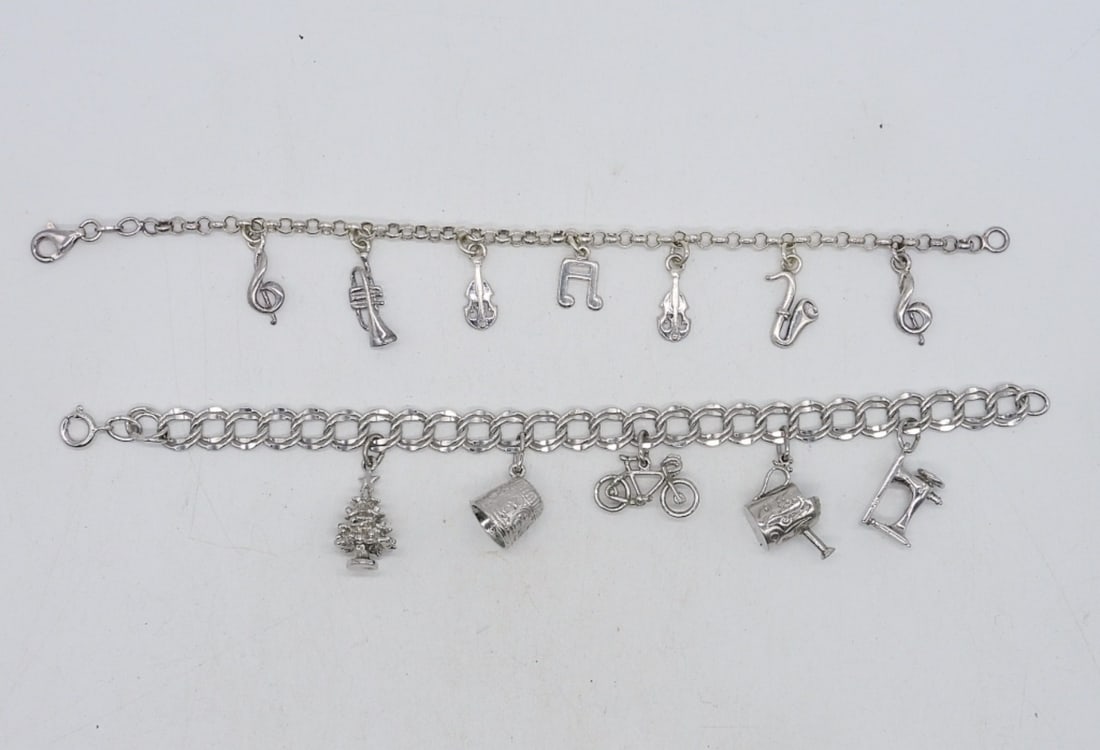 (2) STERLING CHARM BRACELETS: TWO STERLING CHARM BRACELETS, 12 CHARMS. (19.7 DWT)