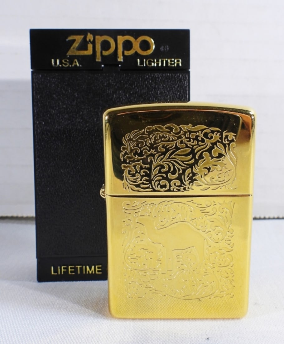 1996 Unfired Zippo Camel Gold tone: In a box, sealed, etched with The Camel logo on the front and back