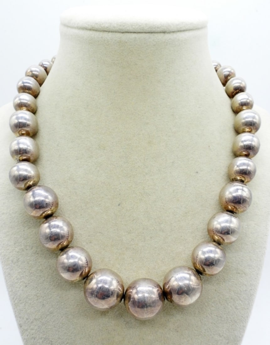 Taxco Sterling Graduated Bead Necklace: Taxco sterling graduated bead necklace, 17". Marked" Mexico TH-13 925". There are a few small dents in some of the sterling beads. (50.4 dwt)