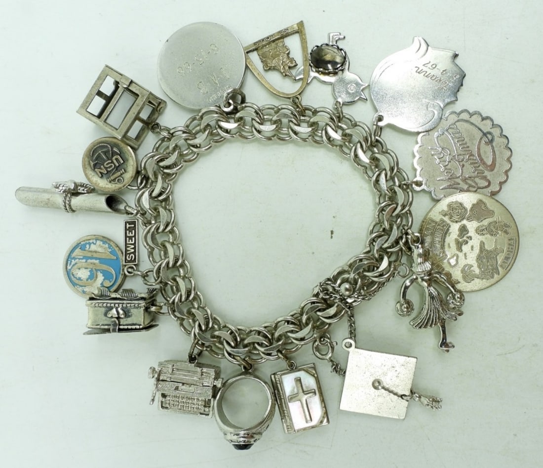Sterling Charm Bracelet with 16 Charms: Vintage sterling charm bracelets with 16 charms. 7". (42.4 dwt)
