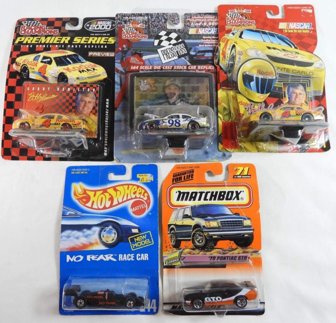 (5) Mixed Lot Of Race Cars: Like New in original packages. Three racing champions #98 hood lifts, and it comes with a press pass.(2) #4 Kodak Bobby Hamilton. One Hot Wheels No Fear #1. And one Matchbox '70 Pontiac GTO #71 of 100