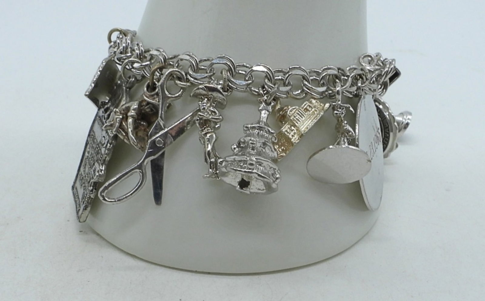 Sterling Charm Bracelets - 20 Charms: Sterling charm bracelet, 7". With 20 charms. Circa mid 1960s. (43.3 dwt)