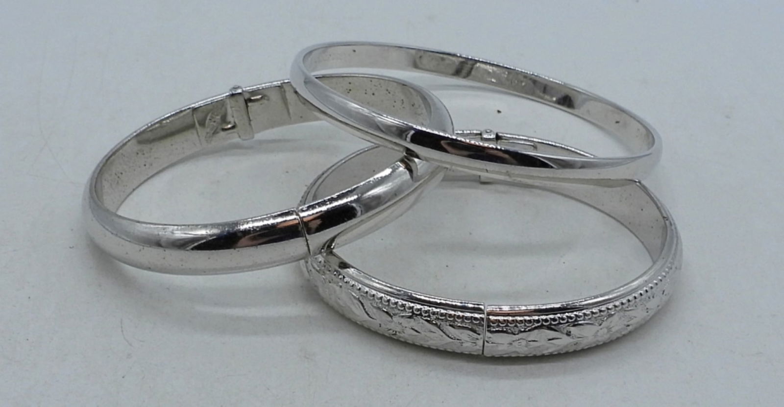 Whiting & Davis And Kate Spade Bracelets: 2 Whiting & Davis 2" diameter, silver tone, cuff bangles, and 1 Kate Spade 2 1/2" diameter silver tone bangle