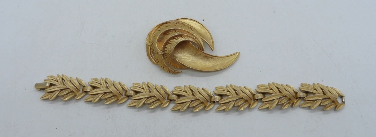 Trifari Brooch and Bracelet: 7 1/2" bracelet with gold tone feather design, and 2 1/2" gold tone broach