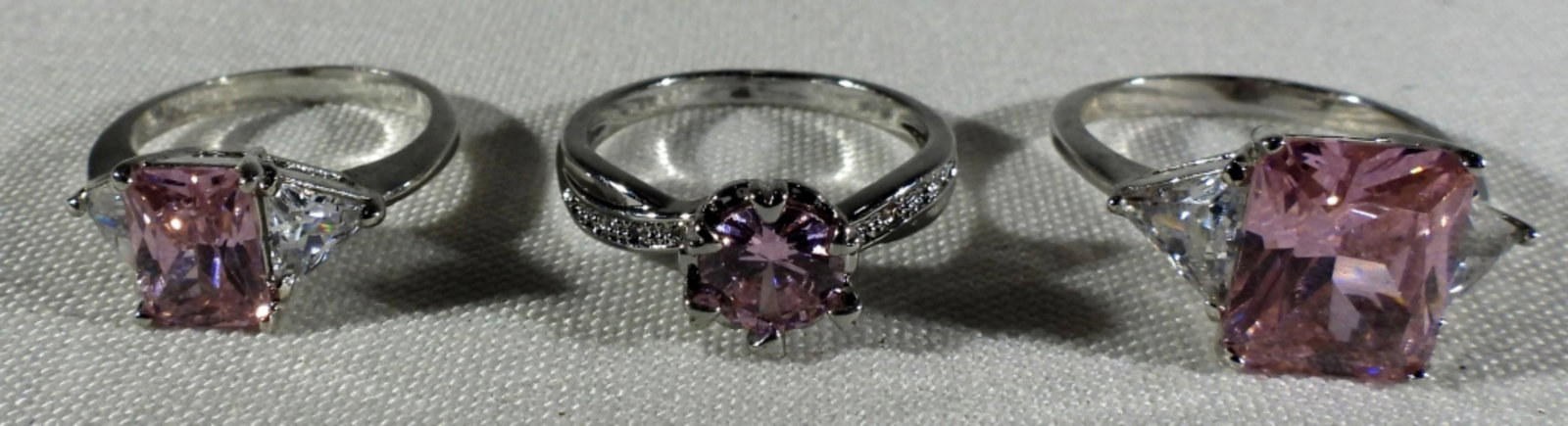 (6) Rings: Stones untested Sizes 4.75-7.5 (5) Pink and white diamonds with silver tone. (1) Pink and white diamonds and gold tone