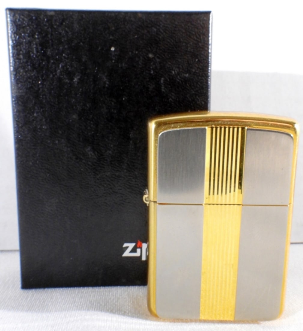 Sealed Gold & Silver Plated Brass Zippo: Comes in its original box. Engraved with "Z" on the bottom right corner.