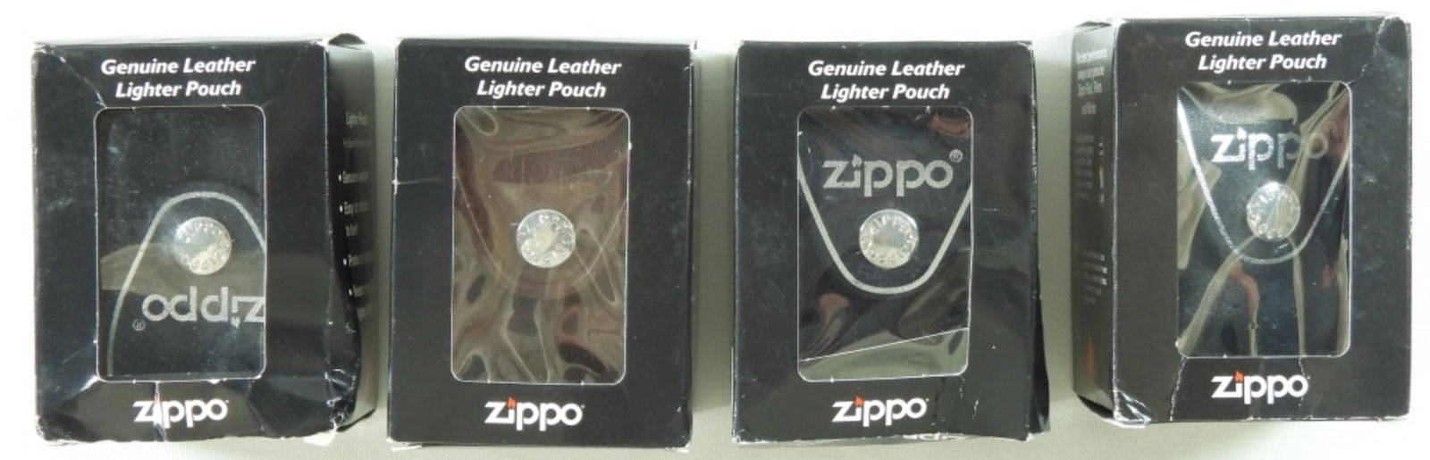 4 Zippo Genuine Leather Pouches: 4 Zippo genuine leather pouches in original boxes, but the boxes have a couple of dents in them.
