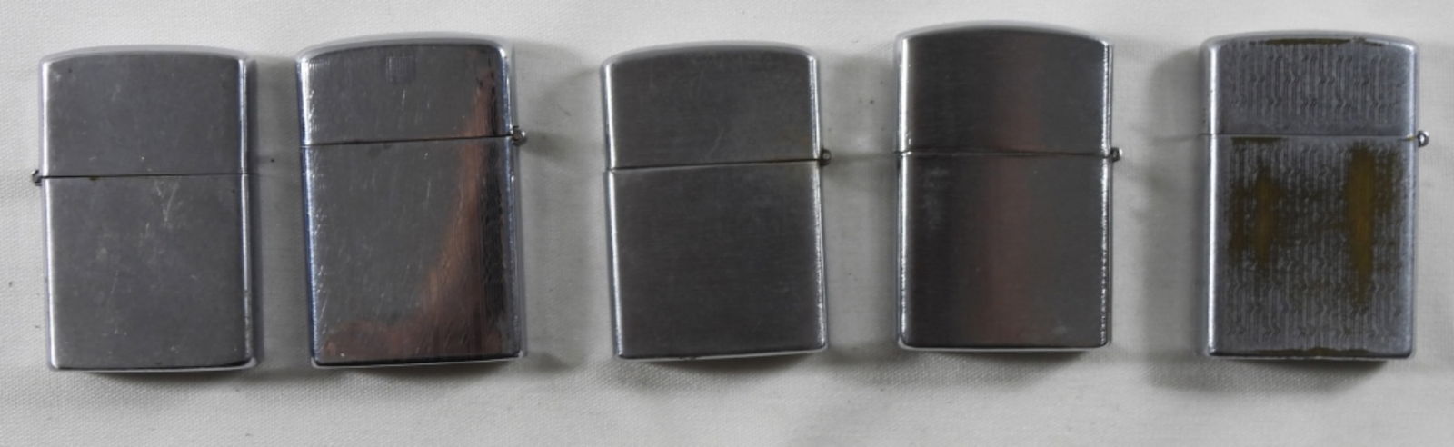 5 Silver-tone Lighters: 5 silver-tone lighters in different shades of silver. Untested as to working.