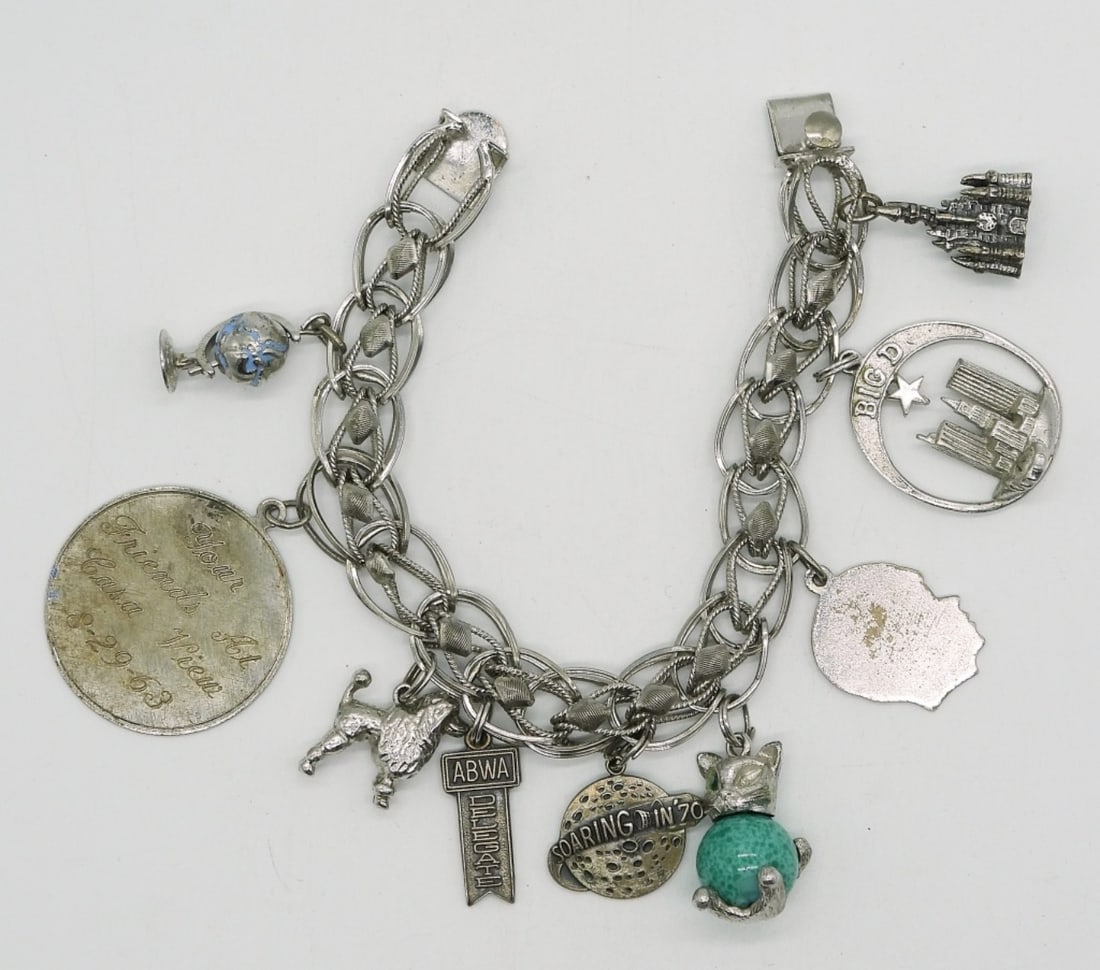 Vintage Sterling Charm Bracelet: Vintage sterling charm bracelet, 9 charms. 7.5" long. (38.3 dwt)