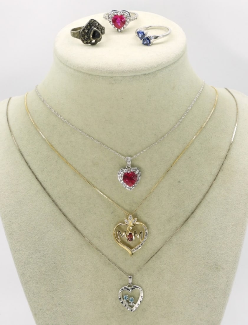 Sterling Heart Necklaces & Rings: Three sterling heart shaped pendants on sterling chains. 18-20". Three sterling rings with heart shaped gemstones. Size 7. (12.5 dwt)