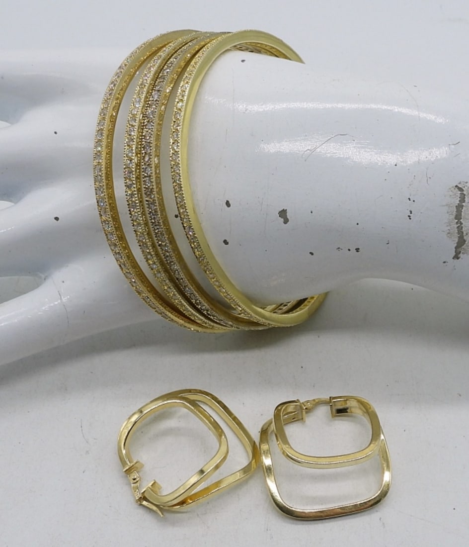 Sterling Gold Tone Bangles & Earrings: Four sterling, gold tone bangle bracelets. One pair of pierced gold tone, sterling earrings. (41.3 DWT)