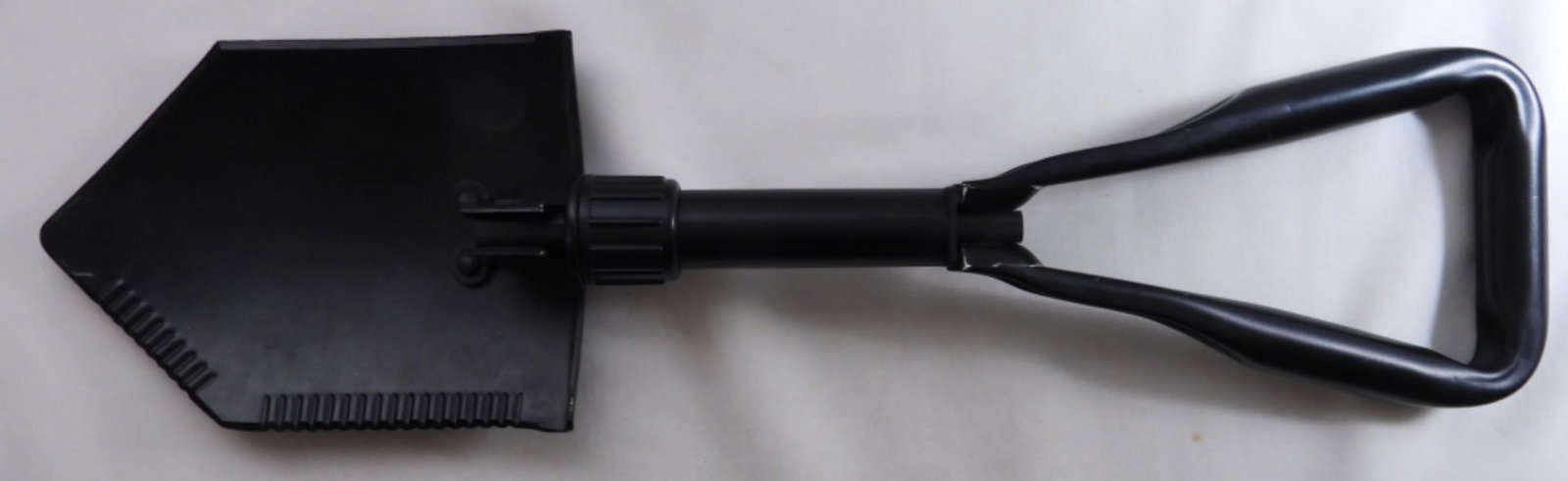 Military Shovel And Pouch: A military shovel and pouch; the shovel is hard to collapse and open.