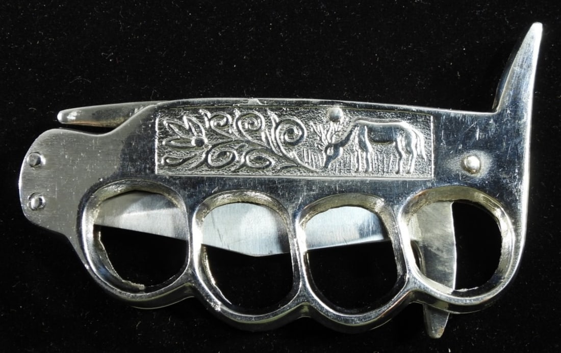 Folding Knuckle Knife- Pakistan: Hefty chrome plated knuckles and knife all in one overall length is 8", blade length is 3 1/4" and approximately 1" wide
