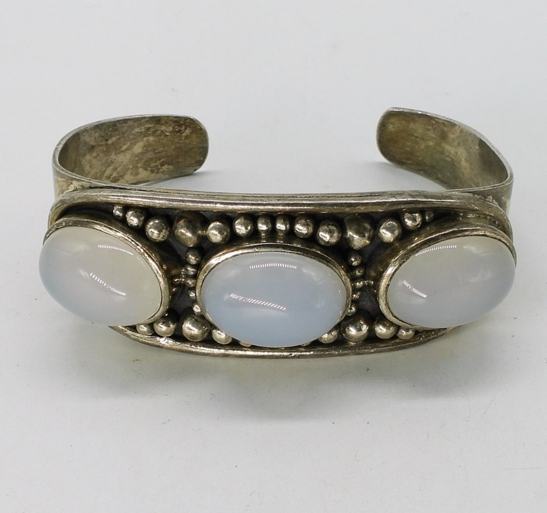 Sterling Moonstone Cuff Bracelet: Sterling cuff bracelet, slightly misshapen. Three moonstone like gems. (29 dwt)