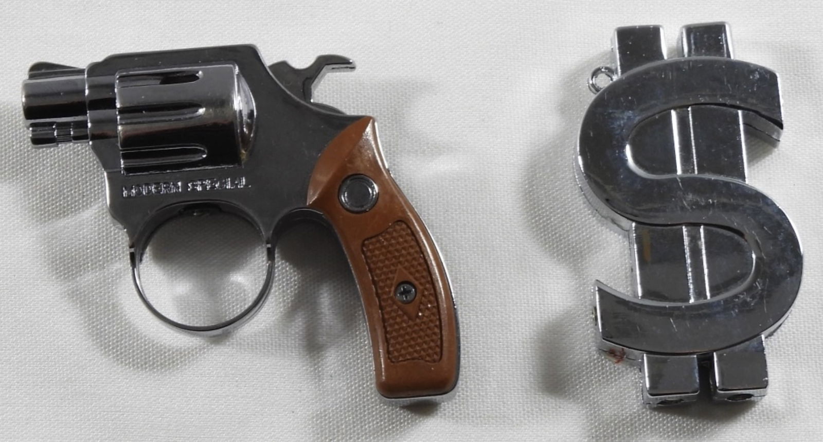 2 Novelty Lighter Set: 2 novelty lighters, 1 is a revolver and the other is a money sign lighter. Untested as to whether it is working or not.