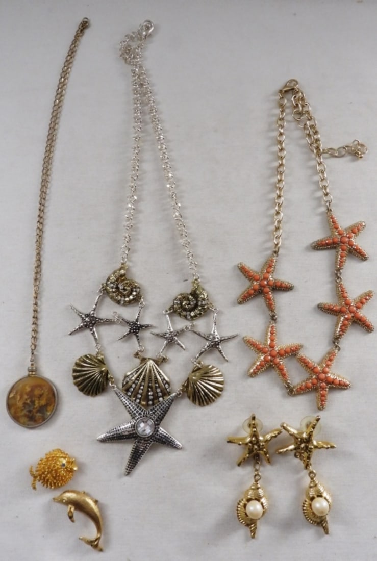 Ocean Lot: 3 necklaces, a pair of post earrings, a dolphin pendant, and a blowfish brooch