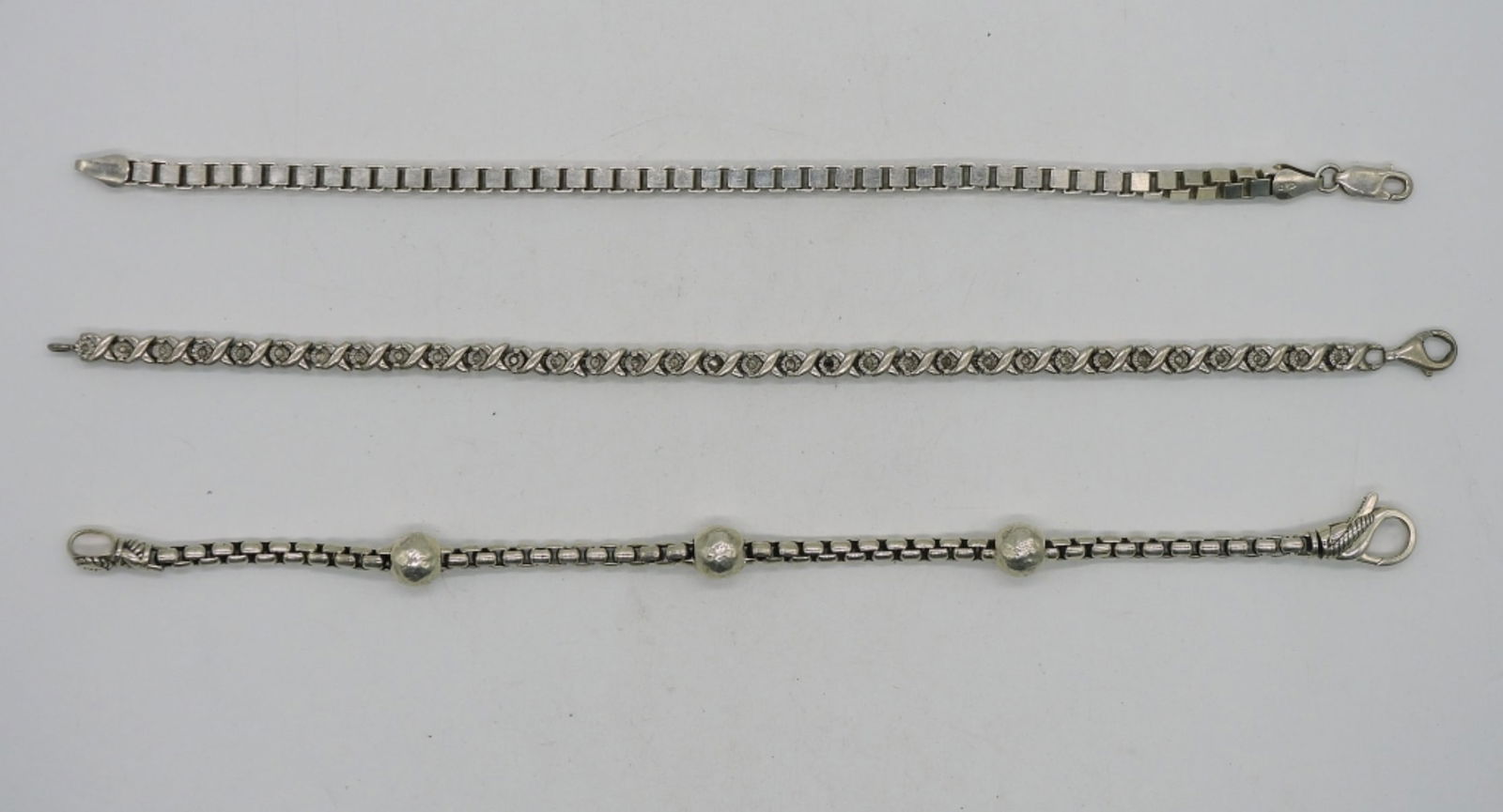 3 Sterling Chain Bracelets: Three sterling silver chain bracelets, 7.5-8". (29.3 dwt)