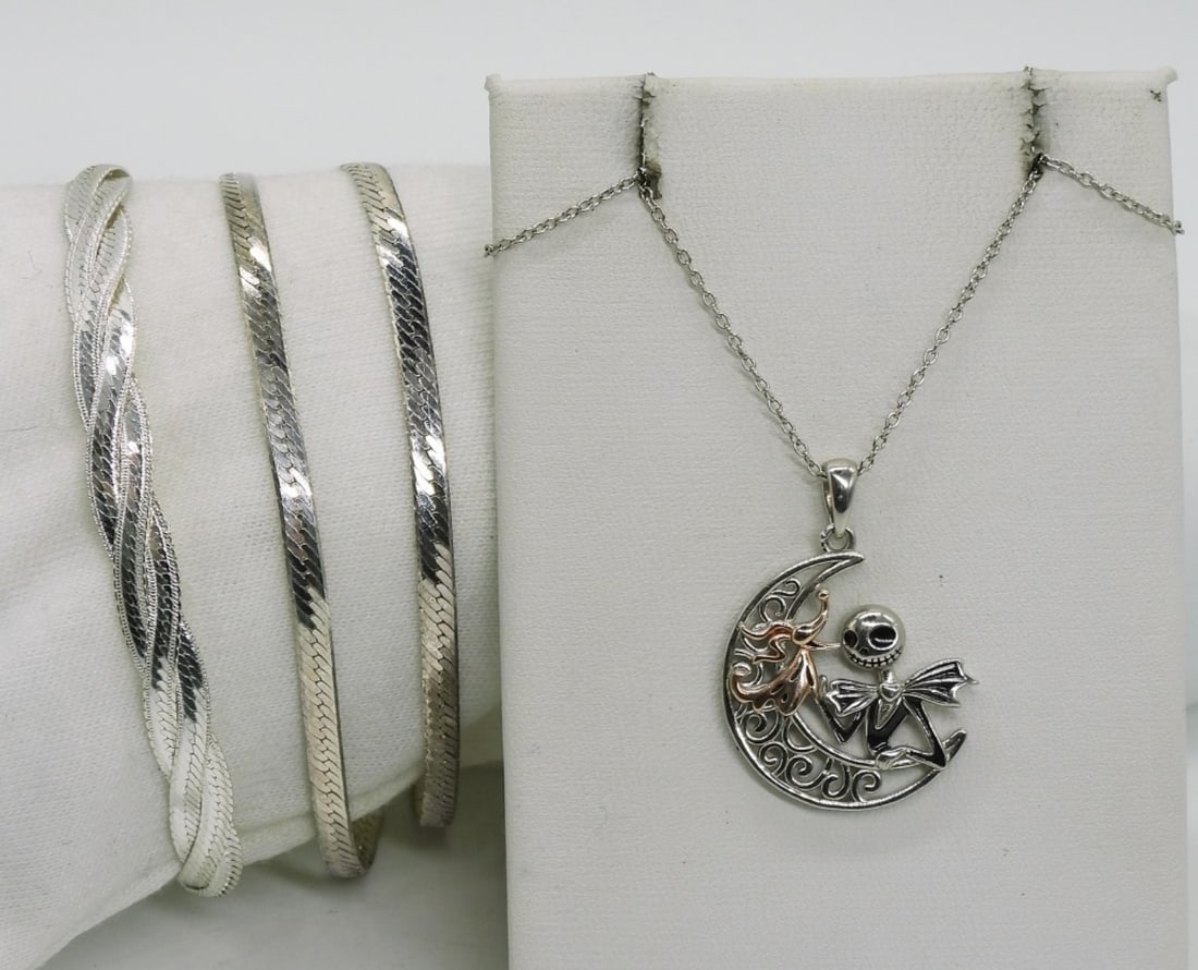 Jack Skellington 925 Necklace, Bracelets: Jack Skellington sterling moon necklace, 20". Three sterling chain bracelets, 7.5-8". (11.3 dwt)