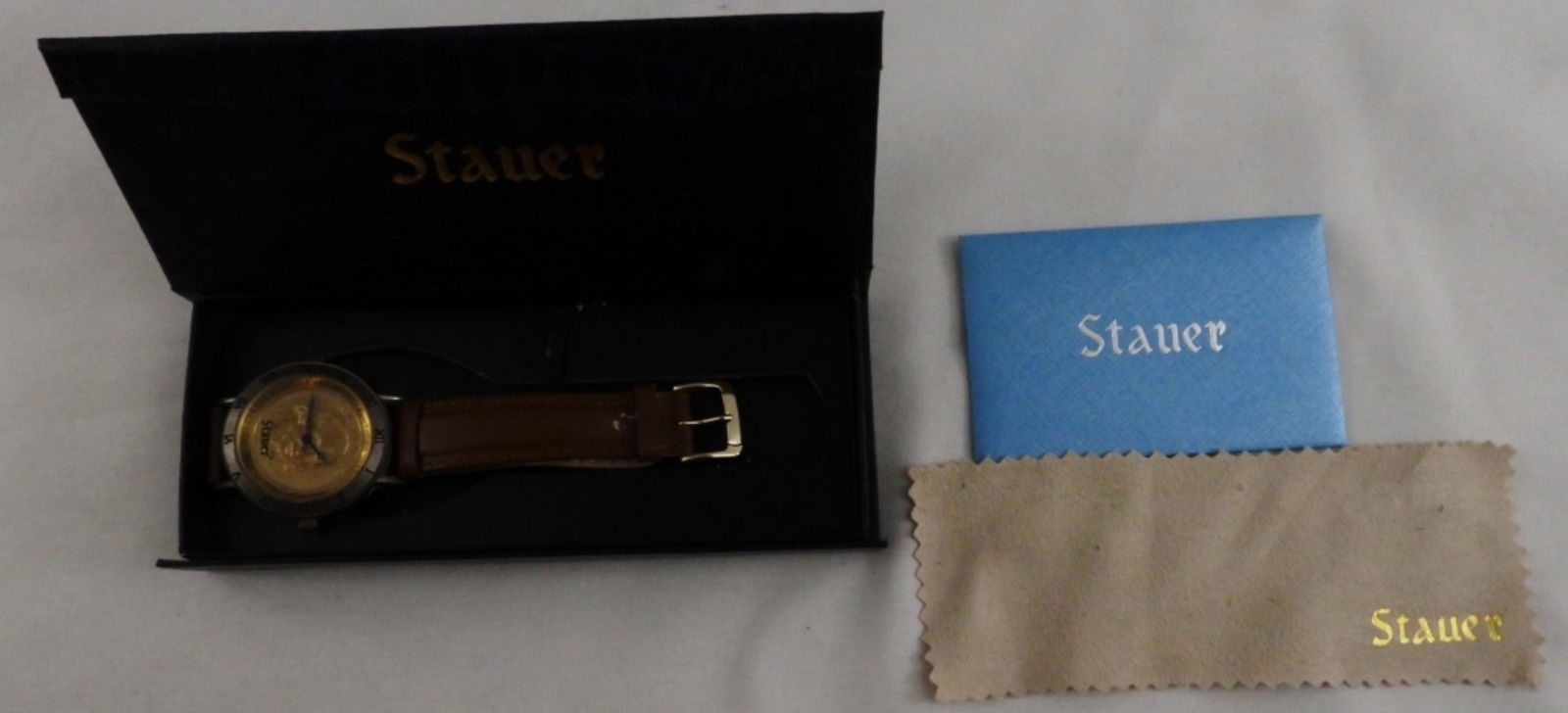 Stauer James Madison Coin Watch: In its original case. Looks to have been worn and has some markings on the band. Genuine Leather, water-resistant. Watches are not verified, authenticated, or tested in running condition unless specif