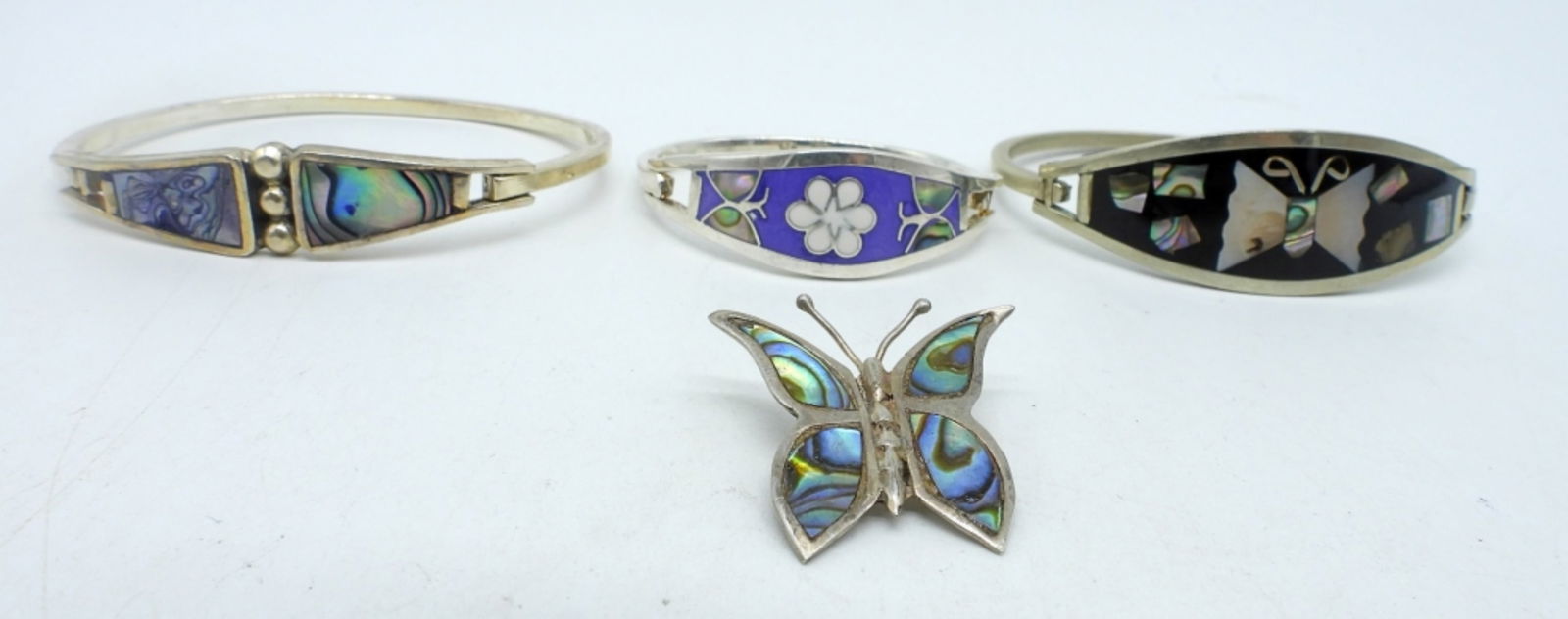 Taxco - Mexico 925 Abalone Inlay Pieces: Taxco 925 child sized abalone hinged bracelet 5". Two Alpaca / Mexico silver, inlay hinged bracelet 7". Mexico butterfly abalone inlay pin. 1". (27.1 DWT)