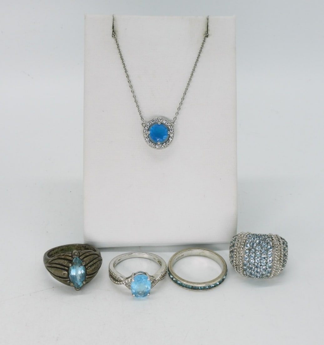 Blue Topaz Sterling Rings & Necklace: Four sterling rings, sizes 5, 7, 8. Bright blue gemstone necklace, unsure of gemstone, 18". (15 dwt)