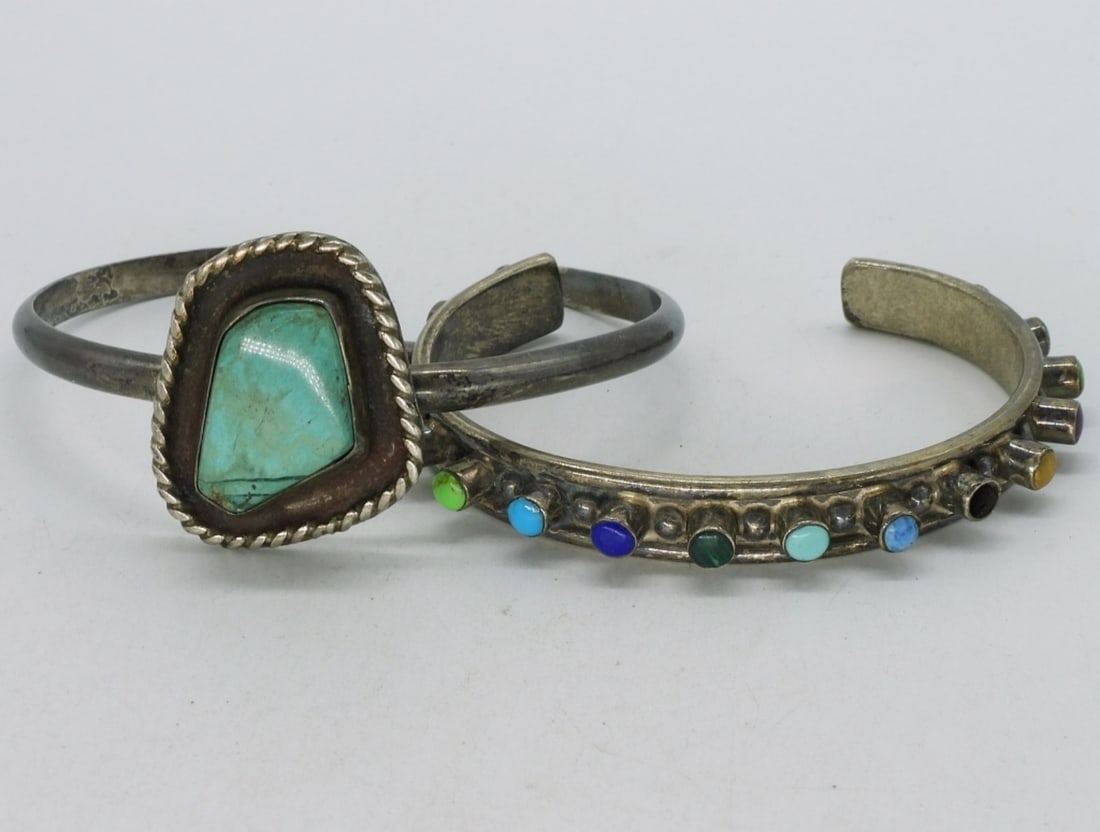 Southwest Style Turquoise Bracelets: Two sterling southwest style cuff bracelets. Turquoise & other gemstones. One small stone missing. (31 dwt)