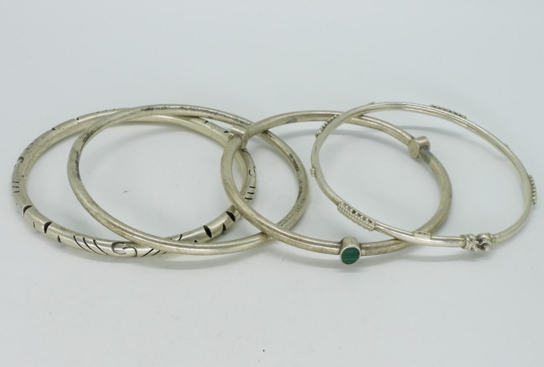 4 Sterling Bangle Bracelets: Four sterling bangle bracelets. One with small malachite gemstones. (27.9 dwt) 6x4x2