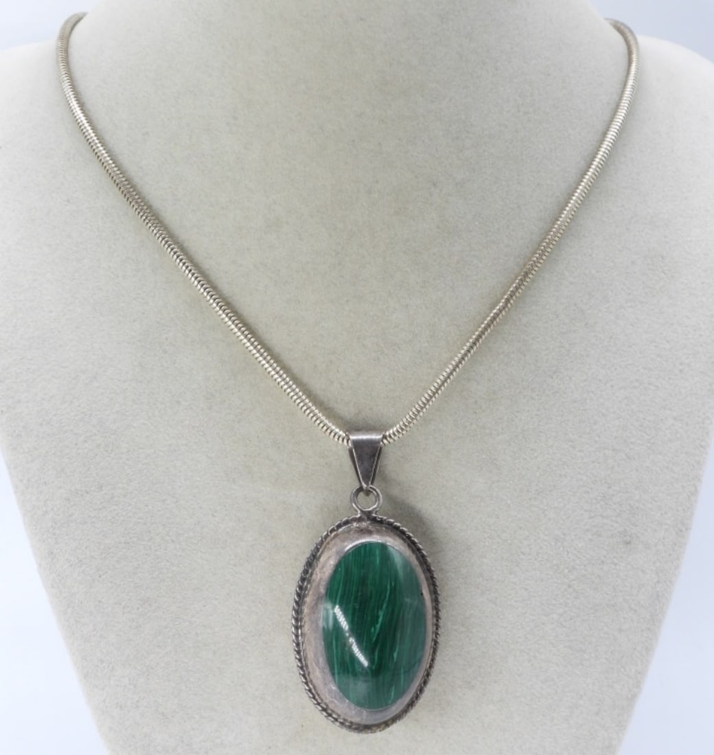 Egg Shaped Double Sided 925 Necklace: Sterling vintage pendant with black onyx on one side and malachite on the other. Pendant is 2.5" long, 1.5" wide. Sterling chain is 20" long. (22 dwt)