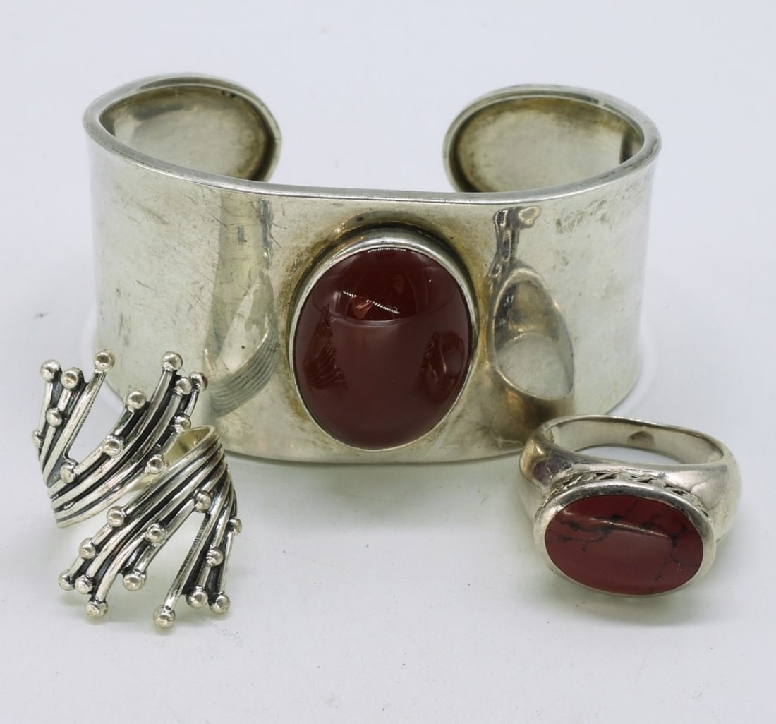 Red Gemstone Sterling Cuff & Rings: Wide sterling cuff bracelet with large red stone, marked "Mexico CII 925". Two sterling rings, size 6 & 7.5 (25.8 dwt)