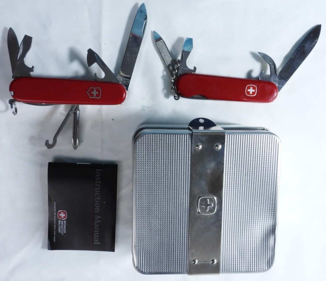 (2) Swiss Army Knives In Silver Color Tin: Tin is dented