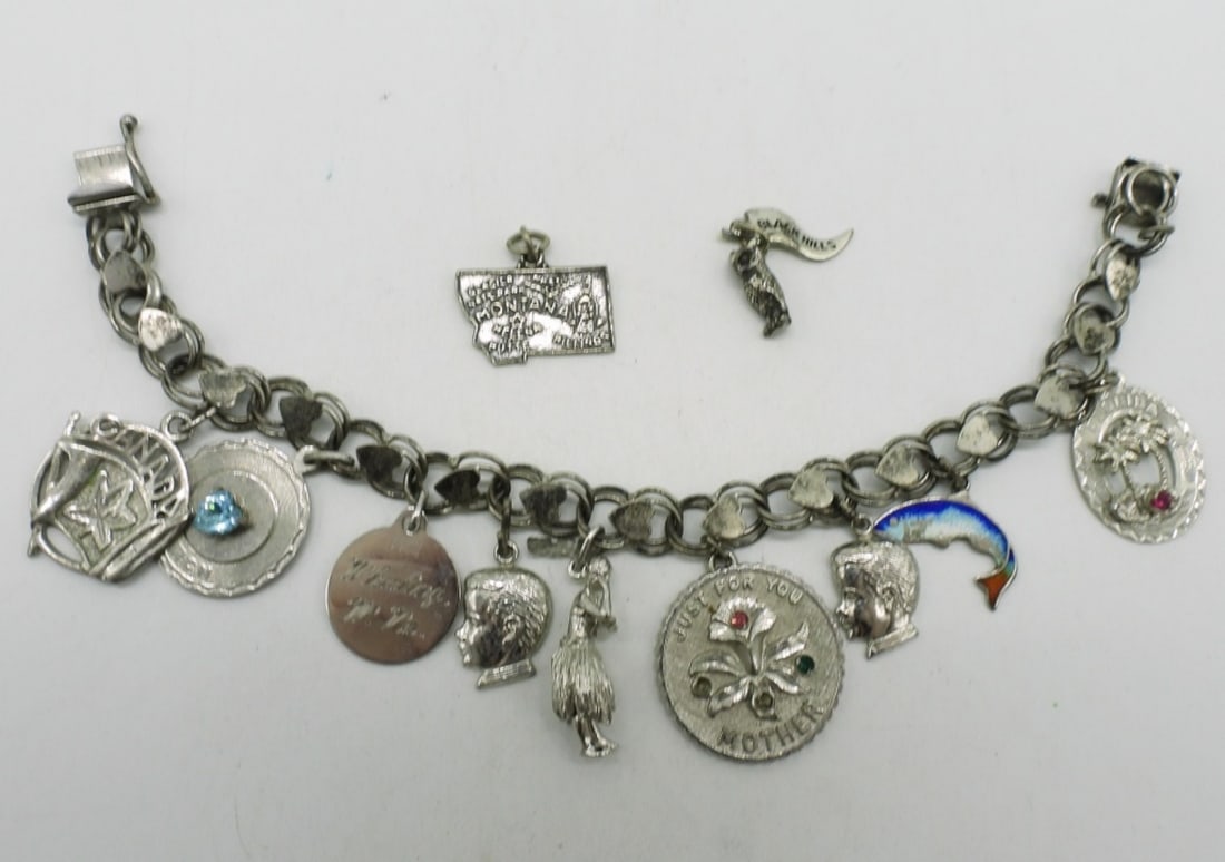 Late 1970's Sterling Charm Bracelet: Late 1970's sterling charm bracelet, 11 charms. 7" long. (23.2 dwt) (6x4x2)