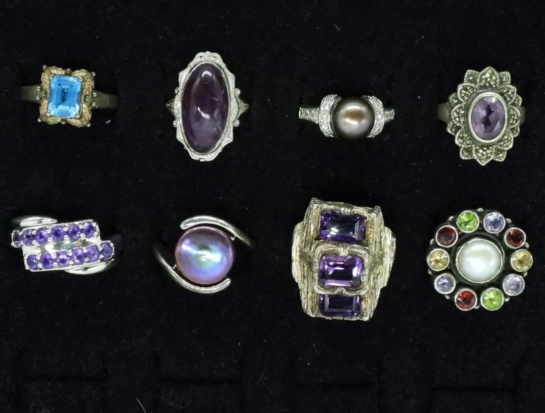 8 Sterling Fashion Gemstone Rings: Eight sterling fashion gemstone rings. Amethyst, pearl, blue topaz. Sizes 5-10 (31 dwt) (6x4x2)