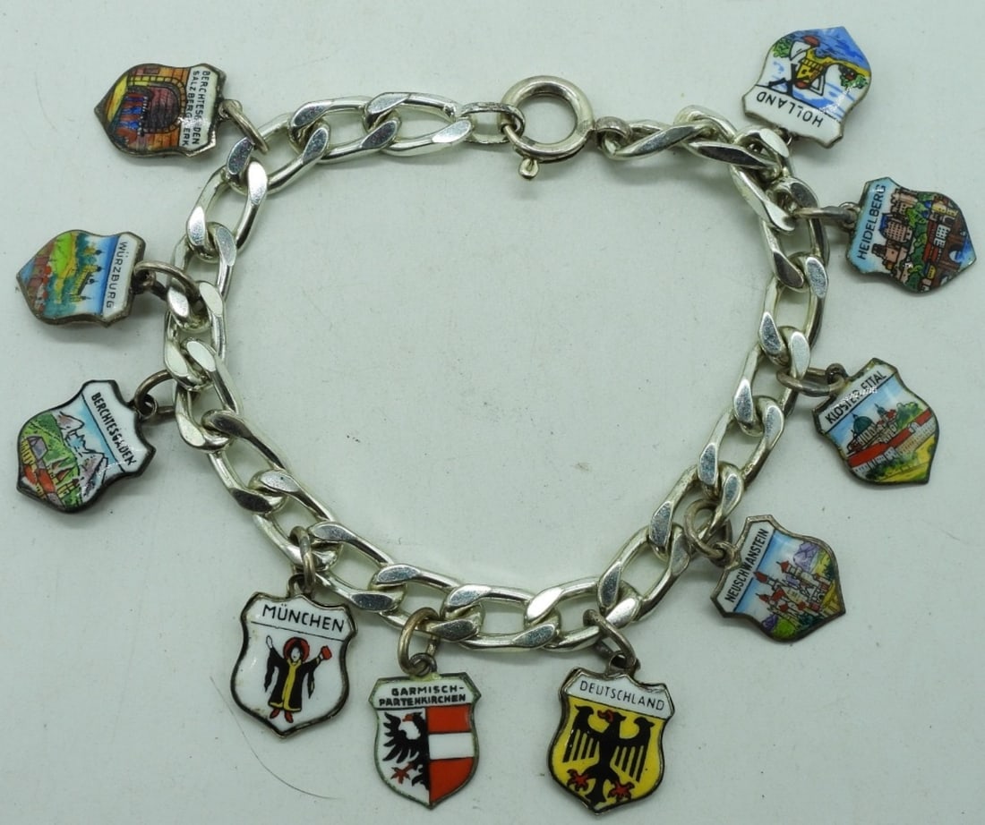 Silver 800 & 835 Charm Bracelet: Bracelet is marked 835 silver. Charms are marked 800 silver. 10 vintage travel charms. Bracelet is 7" long. (18 dwt) (6x4x2)