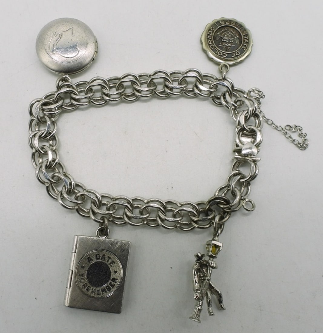 Sterling Charm Bracelet with 4 Charms: Sterling charm bracelet, 7". Four sterling charms, two are lockets. (17.4 dwt) (6x4x2)