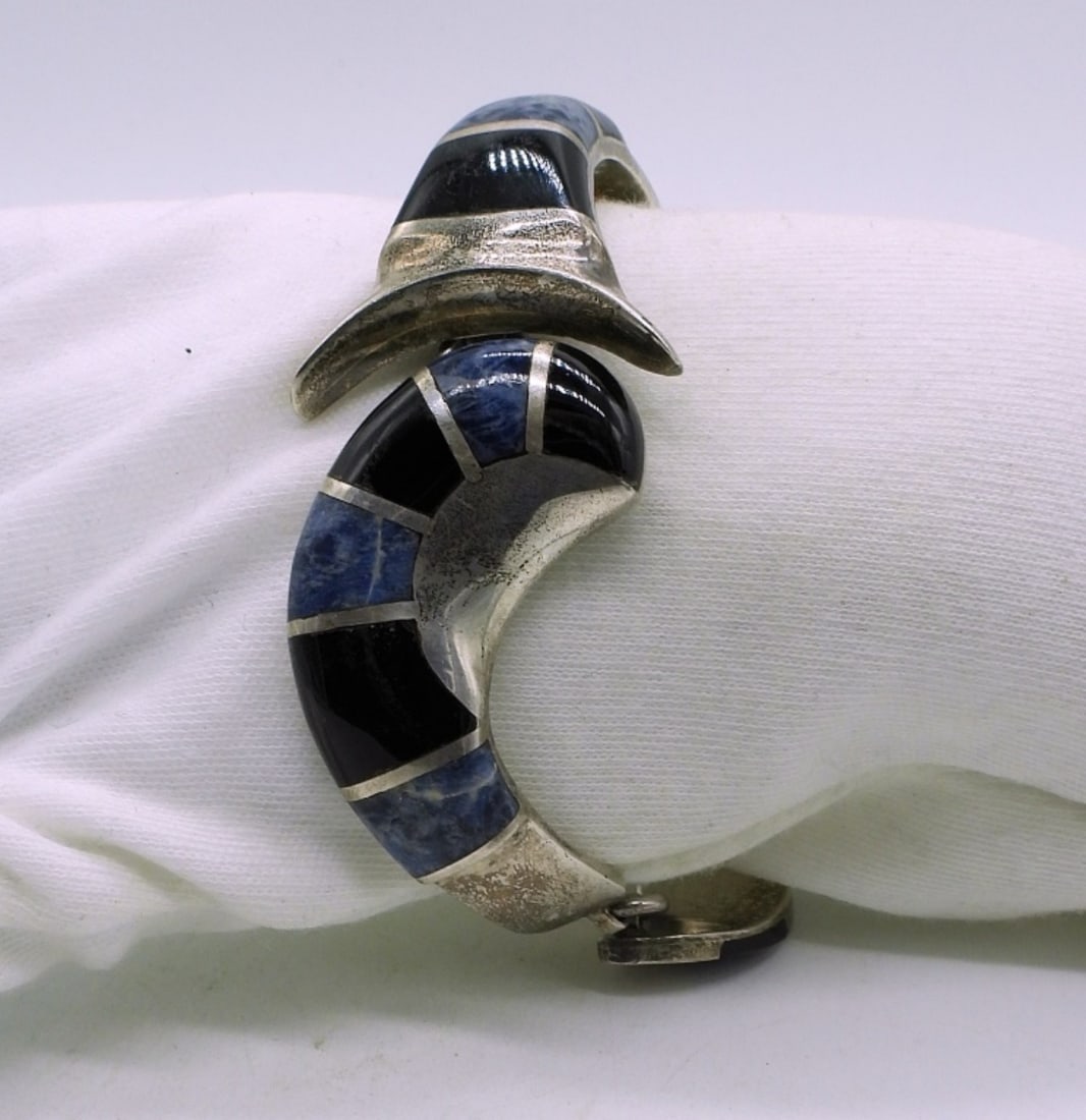 Black Onyx & Blue Sodalite Mexico Bracelet: Vintage sterling bracelet with inlaid black onyx and blue sodalite gemstones. Marked "Mexico 925 JSK". 7". Very Heavy. (43 dwt) (6x4x2)