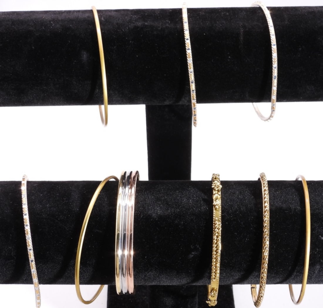 (9) Bracelets: 9- Silver and gold-tone bracelets.