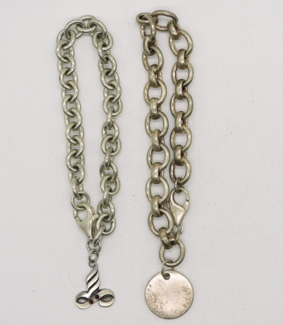 2 Sterling Charm Bracelets - 2 Charms: Two sterling charm bracelets, only 2 charms. 7-7.5". (25.8 dwt)