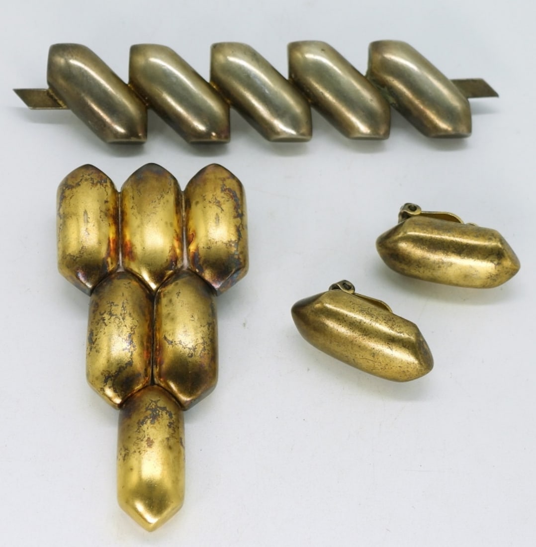 Matching Gold Tone 925 Brooches & More: Gold tone sterling set, marked "M.f. sterling". Brooches are 3" long & 3.5" wide. Clip on earrings are 1". (38.8 dwt)