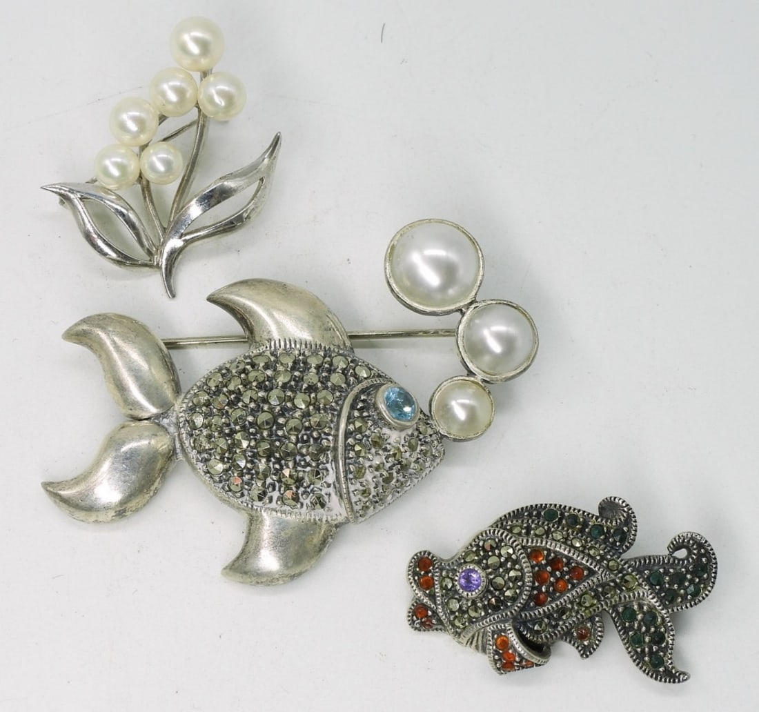 Judith Jack 925 Fish Brooches & More: Two sterling Judith Jack fish brooches, 1.5" & 2" wide. One sterling flower brooch with pearls, 1.5" tall. (19 dwt) (6x4x2)